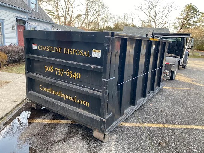 Coastline Disposal dumpster with gold lettering, phone, and coastlinedisposal.com